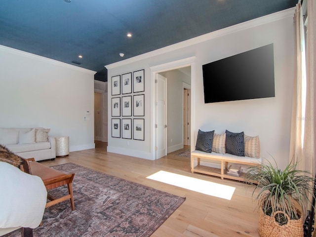 living room with hardwood / wood-style flooring and ornamental molding