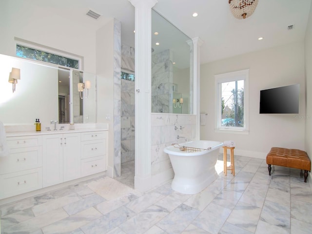 bathroom featuring ornate columns, independent shower and bath, and vanity