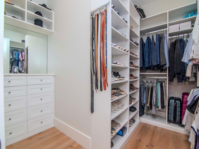 walk in closet featuring light hardwood / wood-style flooring