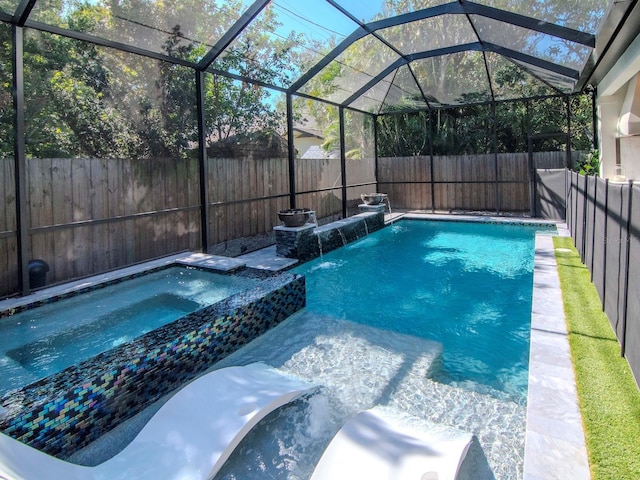 view of swimming pool with an in ground hot tub, a lanai, and pool water feature