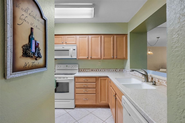 kitchen with white appliances, pendant lighting, sink, and light tile patterned floors