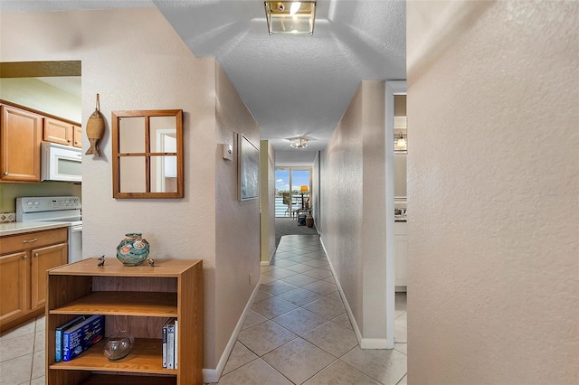 hall featuring light tile patterned flooring