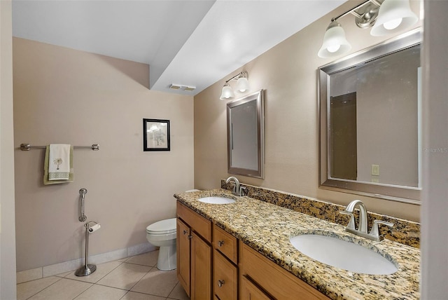 bathroom featuring toilet, tile patterned flooring, and vanity