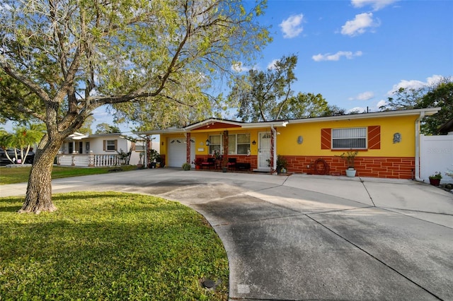 ranch-style home featuring a garage and a front yard