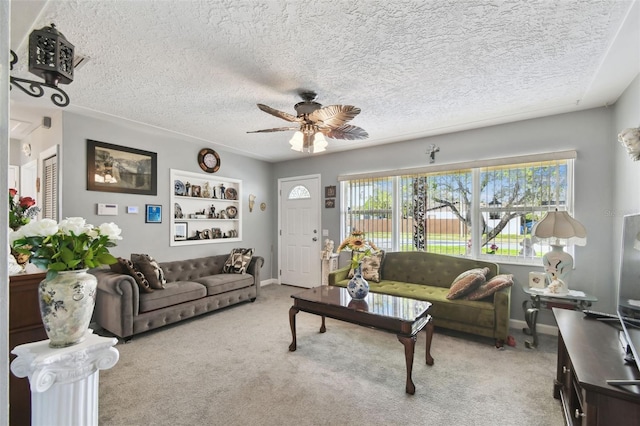 carpeted living room featuring a textured ceiling and ceiling fan