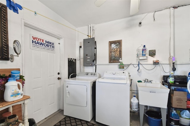 laundry area featuring washing machine and clothes dryer, sink, and electric panel