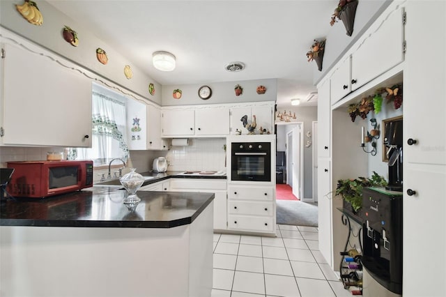 kitchen featuring white cabinetry, sink, oven, decorative backsplash, and kitchen peninsula