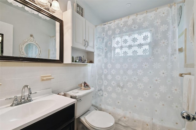 full bathroom with shower / tub combo, tile walls, vanity, tasteful backsplash, and toilet