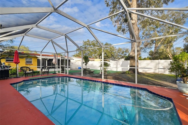 view of swimming pool with a lanai