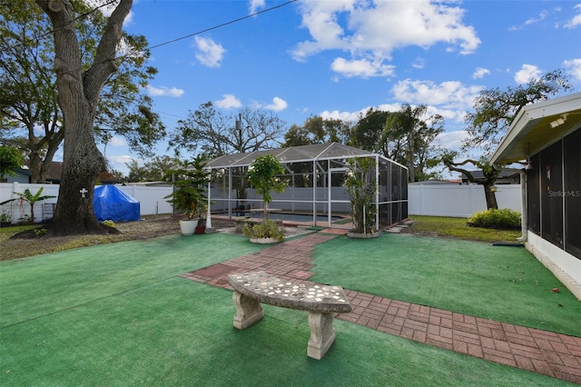 view of yard featuring a lanai and a swimming pool