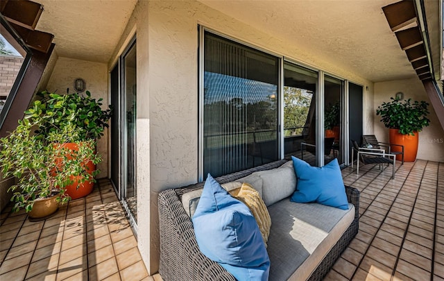 balcony with an outdoor living space and a patio