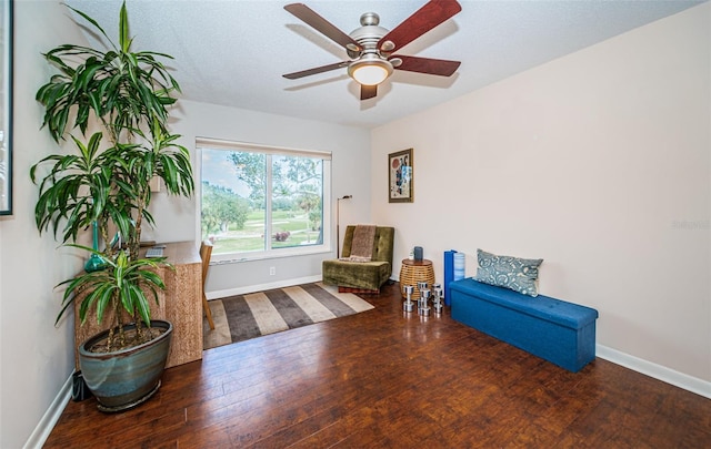 sitting room featuring ceiling fan and hardwood / wood-style flooring