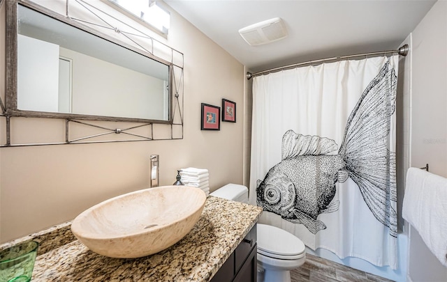 bathroom featuring toilet, a shower with curtain, wood-type flooring, and vanity