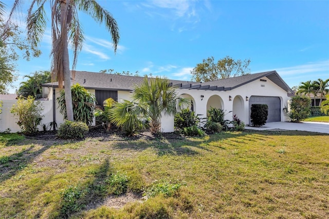 ranch-style home featuring a garage and a front yard