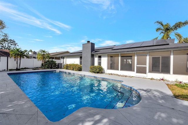 view of swimming pool featuring a sunroom