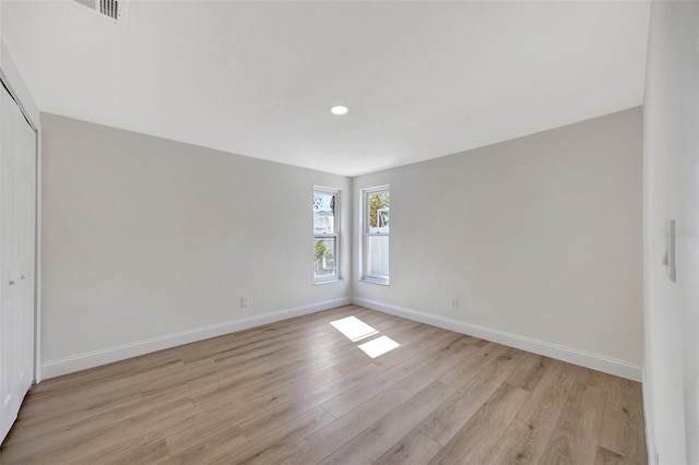 spare room featuring light hardwood / wood-style floors