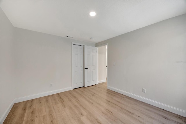 spare room featuring light wood-type flooring