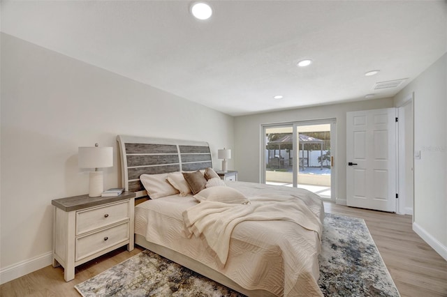 bedroom with light hardwood / wood-style floors and access to exterior