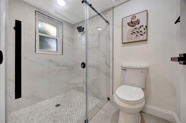 bathroom with toilet and a shower with shower door