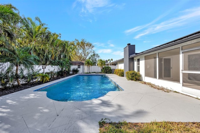 view of pool with a patio and a sunroom