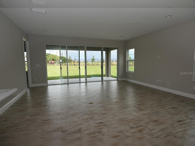 unfurnished room with hardwood / wood-style floors