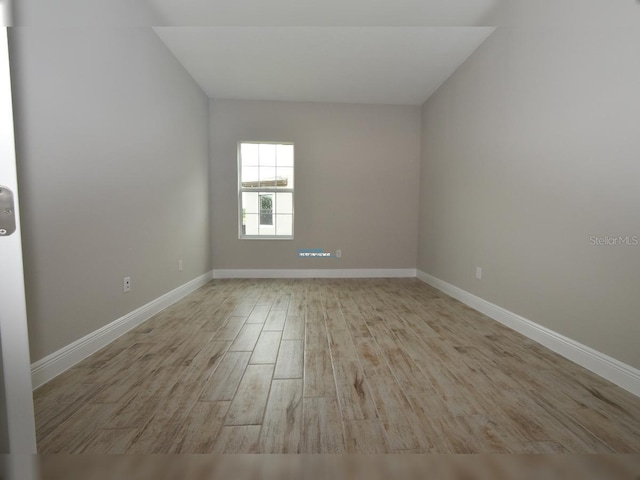 spare room featuring light hardwood / wood-style floors