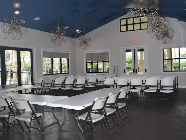 dining space with french doors and lofted ceiling