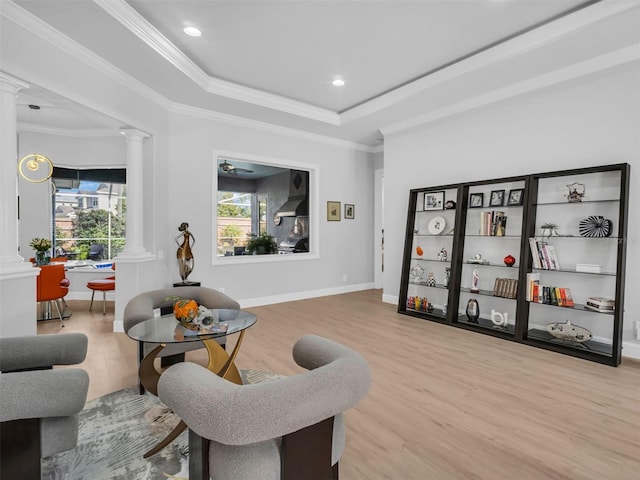 sitting room featuring crown molding, decorative columns, hardwood / wood-style flooring, and a tray ceiling