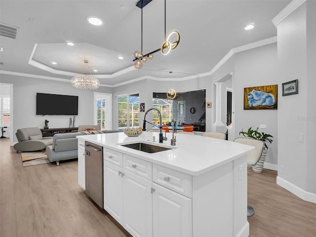 kitchen with white cabinetry, sink, stainless steel dishwasher, a center island with sink, and crown molding