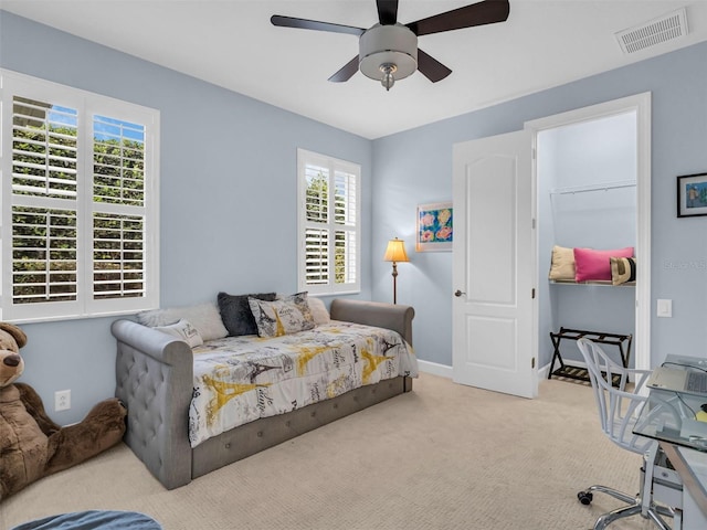 bedroom with ceiling fan and light colored carpet