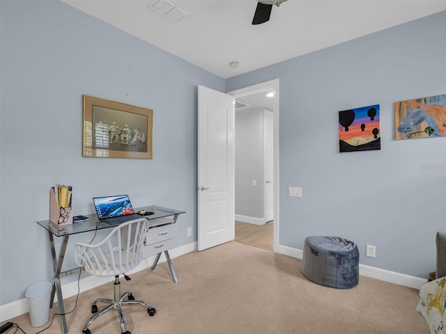 carpeted home office featuring ceiling fan