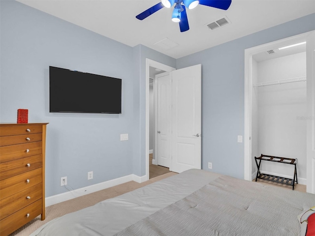 bedroom with a closet, ceiling fan, and light colored carpet