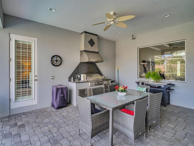 view of patio / terrace with ceiling fan, area for grilling, and a grill