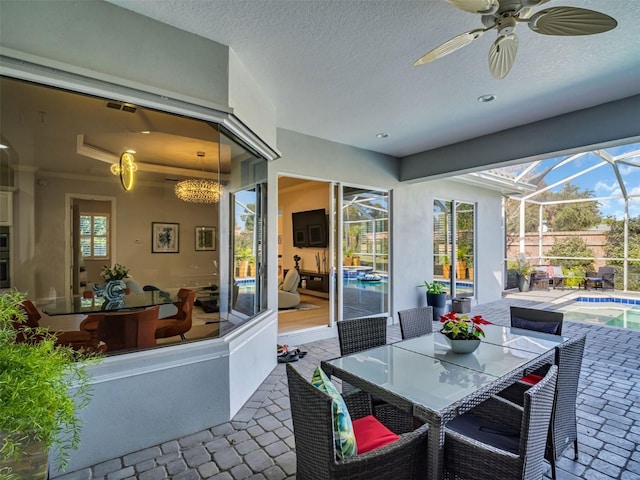 view of patio / terrace featuring ceiling fan and a lanai