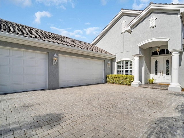 view of front facade featuring a garage and french doors