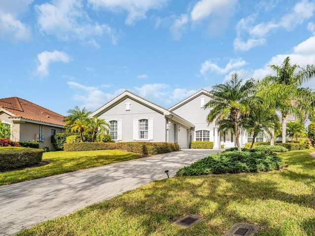 view of front of house featuring a front yard and a garage