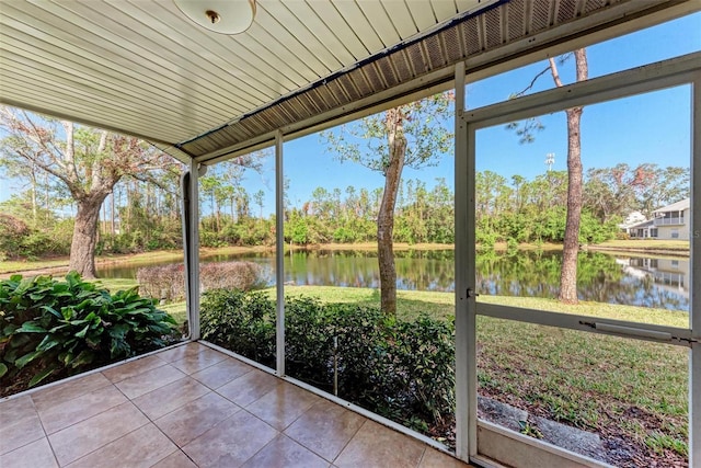 unfurnished sunroom featuring a water view