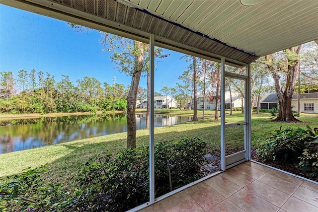 unfurnished sunroom with a water view