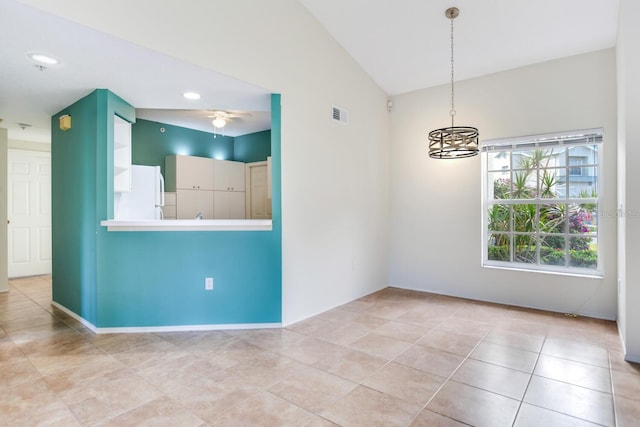 spare room with vaulted ceiling and ceiling fan with notable chandelier