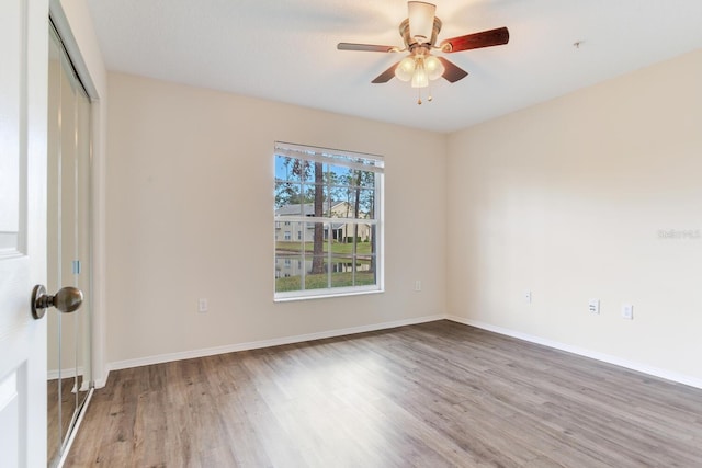 unfurnished room featuring ceiling fan and light wood-type flooring