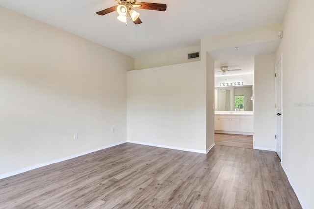 unfurnished room with ceiling fan, sink, and light hardwood / wood-style flooring