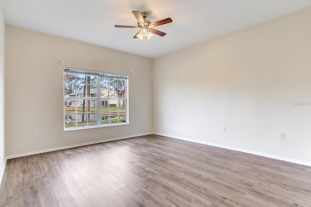 empty room with ceiling fan and light wood-type flooring