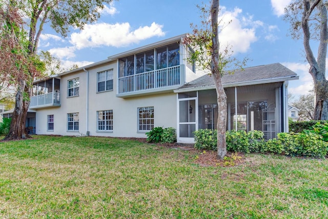 back of property featuring a yard and a sunroom