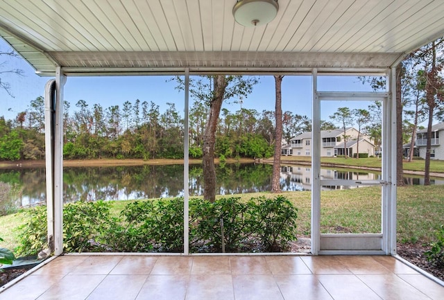 unfurnished sunroom with a water view and a wealth of natural light