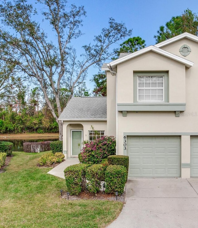 front of property with a garage and a front lawn