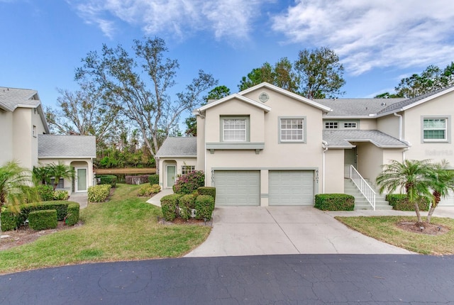 view of front facade featuring a shingled roof, concrete driveway, a front yard, stucco siding, and an attached garage