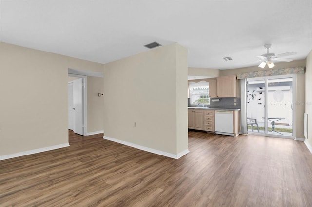 unfurnished living room with ceiling fan and dark hardwood / wood-style floors