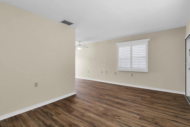 empty room featuring ceiling fan and dark hardwood / wood-style floors