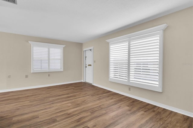 spare room featuring wood-type flooring