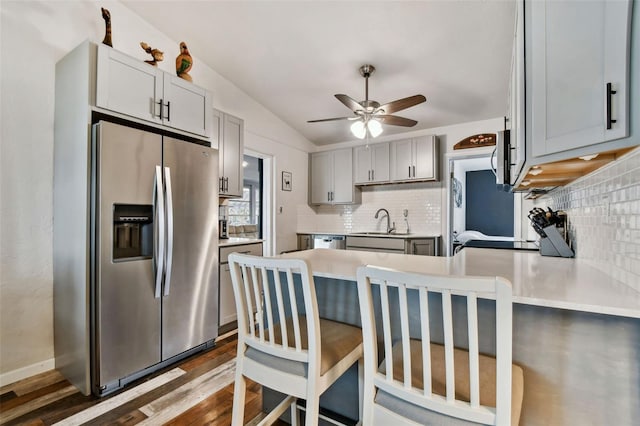 kitchen featuring stainless steel appliances, dark hardwood / wood-style flooring, sink, and gray cabinets